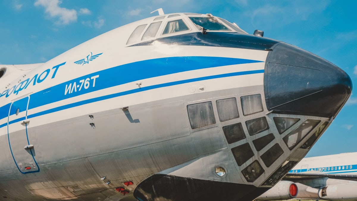 Close-up of IL-76T cargo aircraft displaying iconic Aeroflot branding at a sunny airfield.